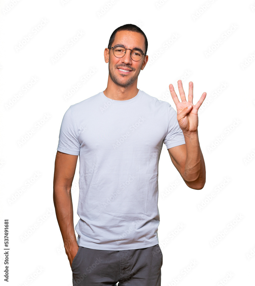 Young man making a number four gesture Young man making a number four gesture