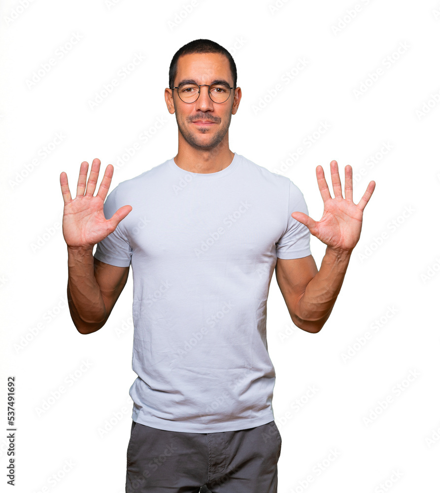 Young man making a number ten gesture Young man making a number ten gesture