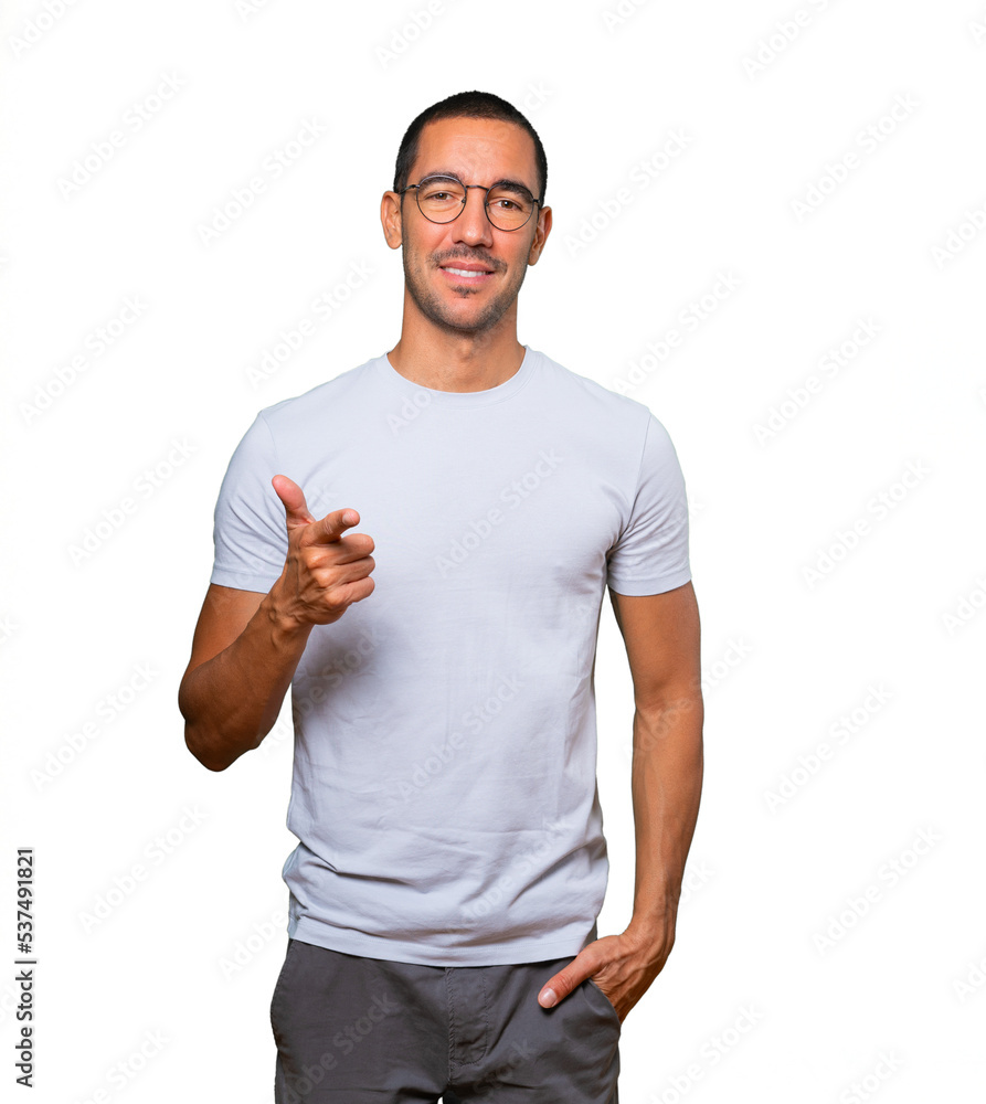 Happy young man pointing at you with his finger Happy young man pointing at you with his finger