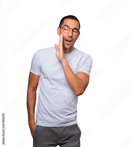 Confident young man telling a secret