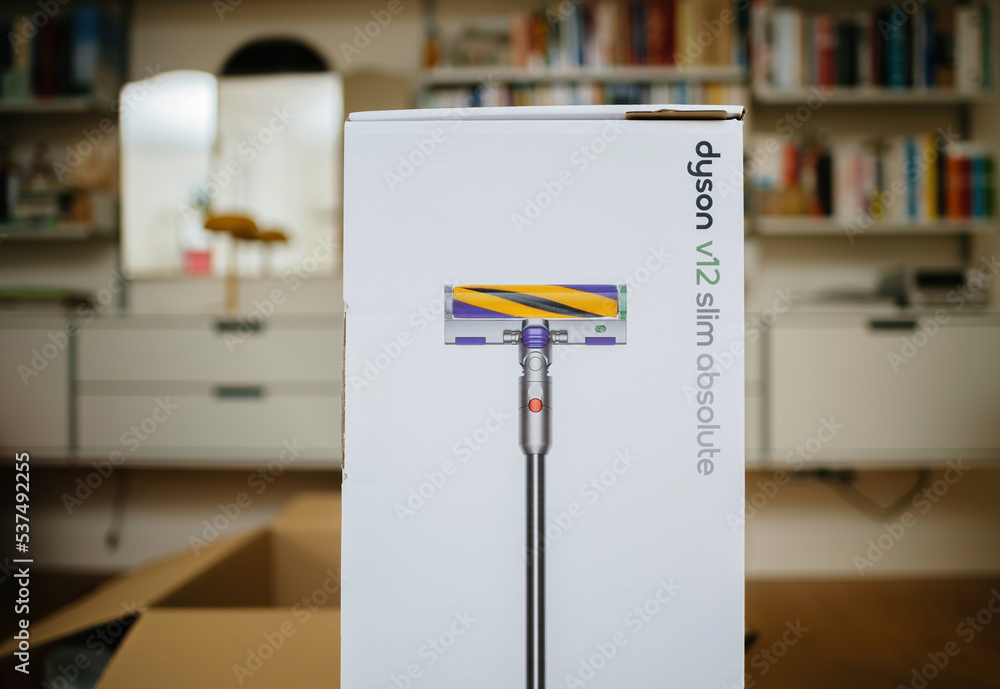 Paris, France - Jul 16, 2022: Close-up of cardboard box package of new  cordless vacuum battery operated cleaner by Dyson V12 slim absolute with  living room shelves in background Photos | Adobe Stock