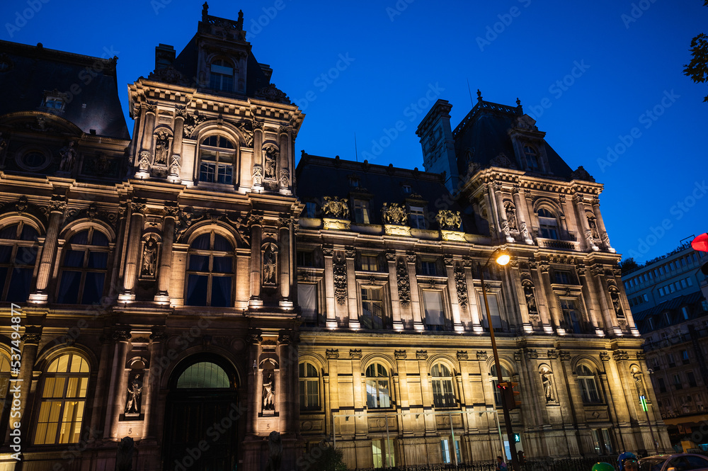 Fototapeta premium Paris Tourism Office is in the north wing of the Hotel de Ville (City Hall) located in famous le Marais district, Paris, France. Night scene, lit up building