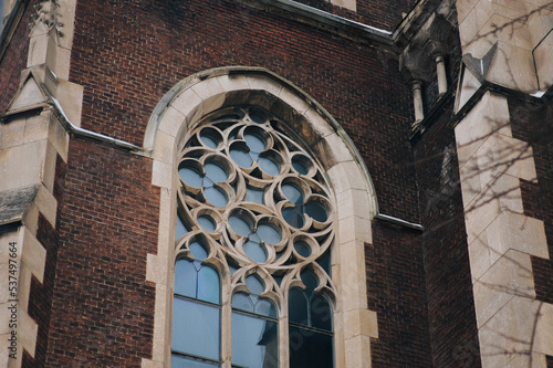 Elongated vintage window on the facade of the ancient building. Baroque and Gothic architecture. Church of St. Olga and Elizabeth. Lviv, Ukraine.