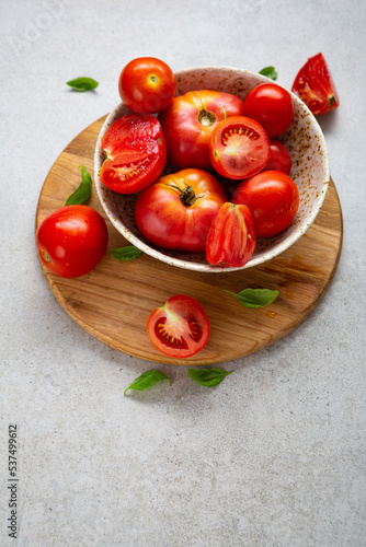 Close up of red tomatoes on wooden board in bowl food healthy cooking food