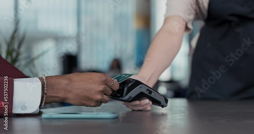Close-up of a man's hand paying with a bank card for an order at a restaurant. Successful transaction using the terminal.