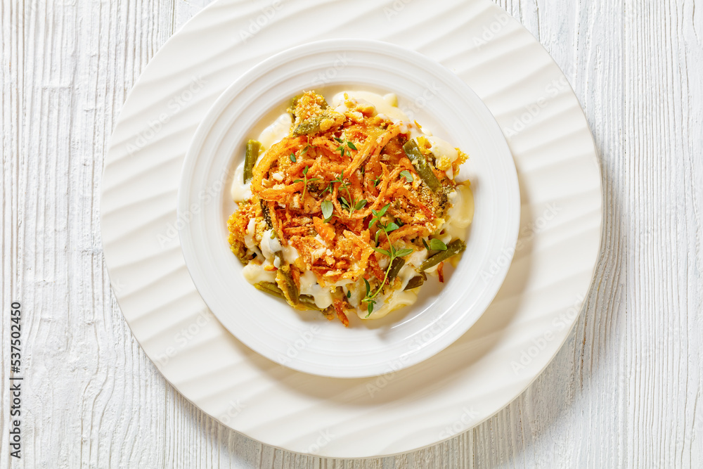 cheesy green bean casserole on plate, top view cheesy green bean casserole on plate, top view