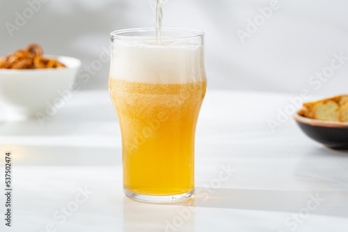 Pouring beer in glass light craft foam food and drink