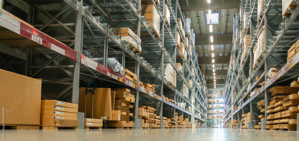 Panoramic view of a large warehouse in the aisle between shelves and racks Panoramic view of a large warehouse in the aisle between shelves and racks
