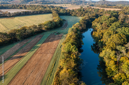 Aerial view of a turf farm with a irrigation system the sod for lawns and green grass. The farm boarders a beautiful river and forest in southern Tennessee, U.S.A.