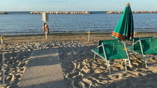 Gabicce, Pesaro Urbino, Italy . Sand and umbrellas at the beach of Gabicce Mare. Concept for summer, beach, Italy, nature, fun, holydays, relax photo