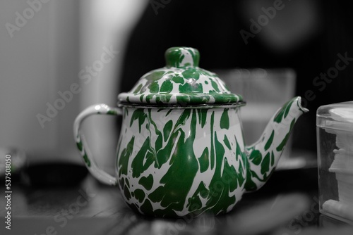 Closeup shot of a classic Teko enamel teapot and tissue box with blur background photo