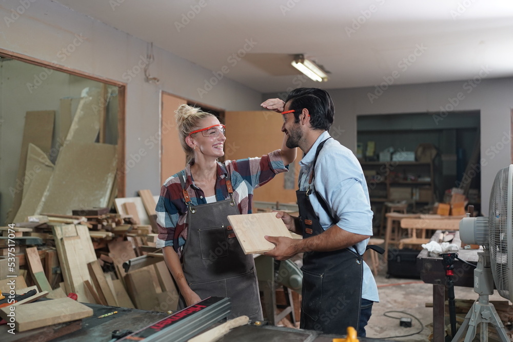 Contemporary Carpenter Working, Portrait of modern carpenter making wood furniture while working in joinery lit by sunlight with factory background on small business concept, copy space