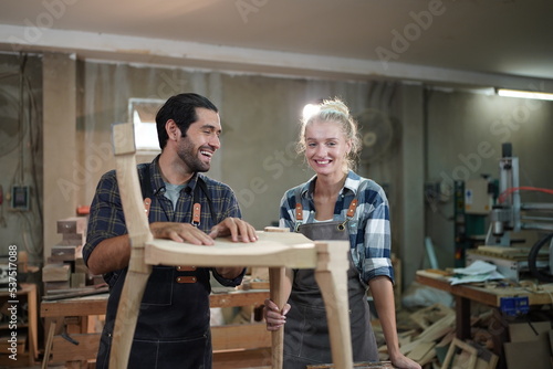 Contemporary Carpenter Working, Portrait of modern carpenter making wood furniture while working in joinery lit by sunlight with factory background on small business concept, copy space