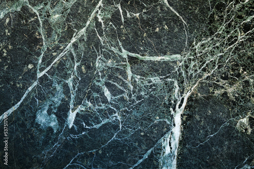 Texture of deep green marble stone, close up, front view