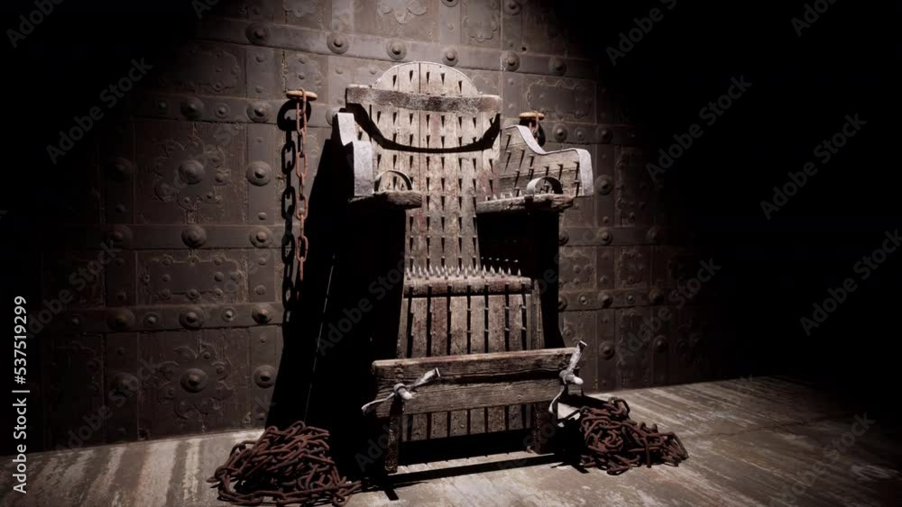 A close-up view of the torture chair and chains used in a medieval torture chamber.