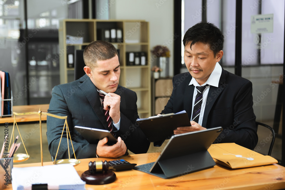Asian business team and lawyers discussing contract papers sitting at the table. Concepts of law, advice, legal services. at office Asian business team and lawyers discussing contract papers sitting at the table. Concepts of law, advice, legal services. at office