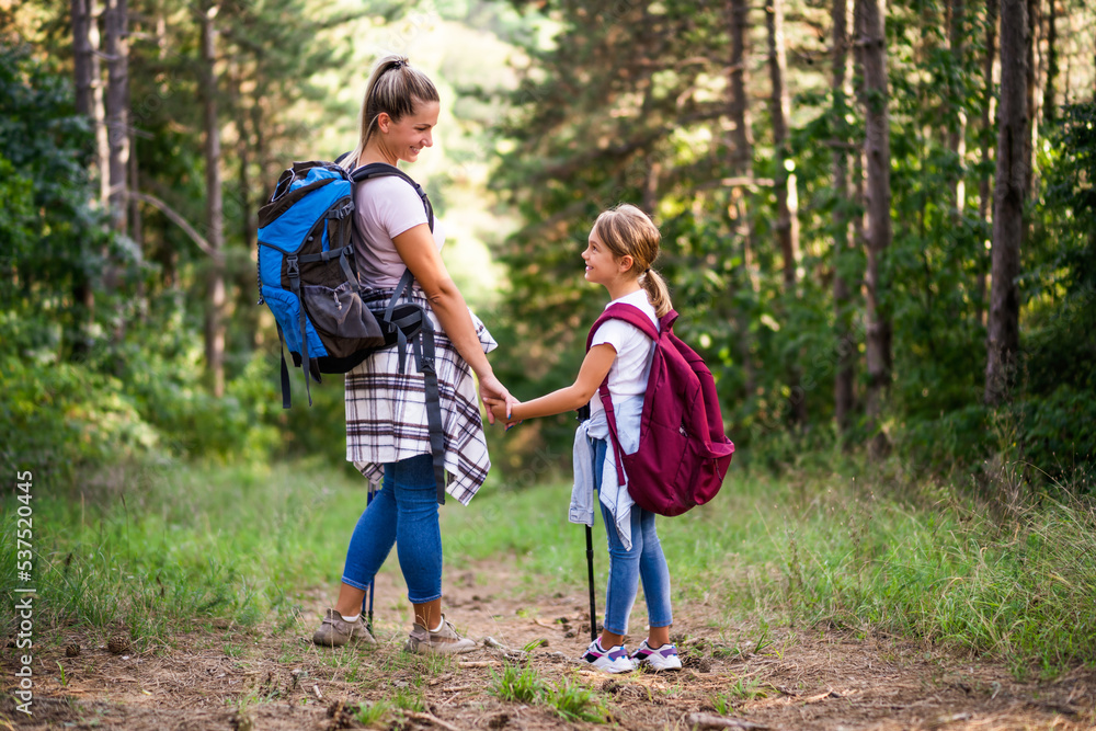 Mother and daughter enjoy hiking together. Mother and daughter enjoy hiking together.