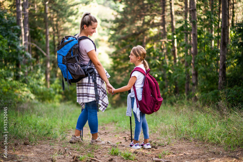 Mother and daughter enjoy hiking together. 