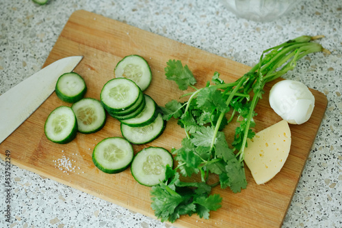 slicing simple rustic food of cucumbers, cheese and eggs