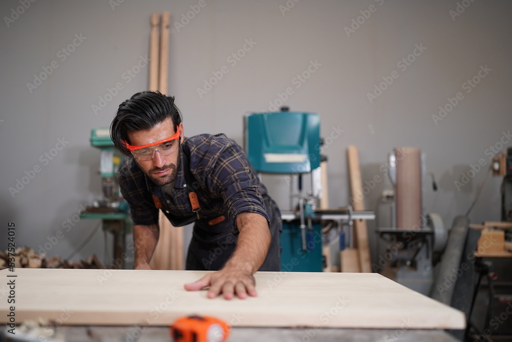 Contemporary Carpenter Working, Portrait of modern carpenter making wood furniture while working in joinery lit by sunlight with factory background on small business concept, copy space Contemporary Carpenter Working, Portrait of modern carpenter making wood furniture while working in joinery lit by sunlight with factory background on small business concept, copy space