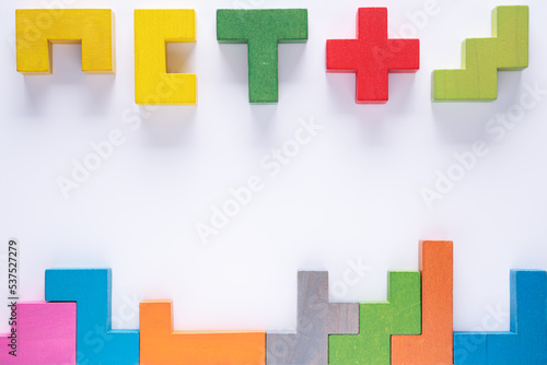 Top view on colorful wooden blocks folding on white background.