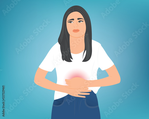 Young woman putting her hand on her stomach due to stomach pain, food poisoning or menstrual pain.