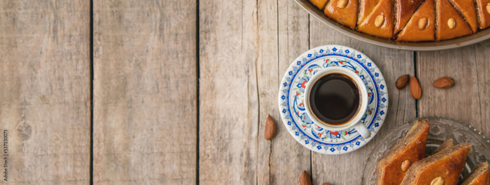 A cup of Turkish coffee and baklava. Selective focus. A cup of Turkish coffee and baklava. Selective focus.