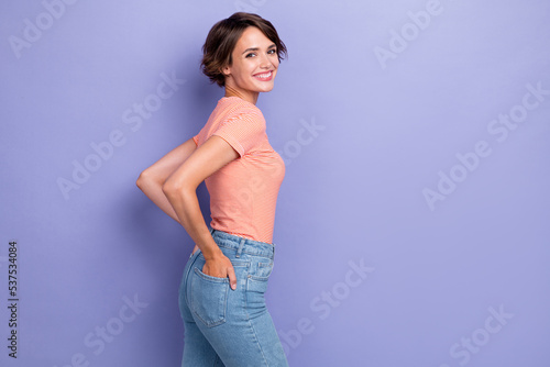 Photo of cute nice lady wear striped outfit arm pocket satisfied quality clothes stand empty space isolated on purple color background