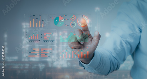 Hand pointing Business data analytics process management with KPI financial charts and graph and automated marketing dashboard. businesswoman point graph dashboard analysis on industrial background.