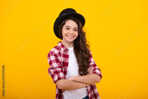 Kids girl in old fashion clothes. Elegent hat, cylinder hat isolated on yellow background. Headwear. Clothes accessories. Fashion headwear for gentlemen in vintage style, old classic cylinder.