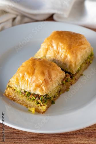 Pistachio baklava on wooden background. Traditional Turkish cuisine delicacies. close up