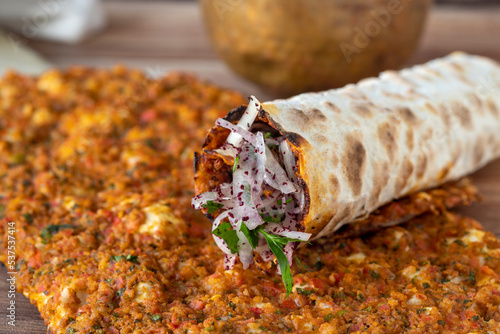 Lahmacun or Turkish pizza with minced meat on a wood background. Turkish foods. close up