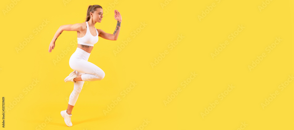 fitness girl jumping in sportswear on yellow background. Woman jumping running banner with mock up copyspace.