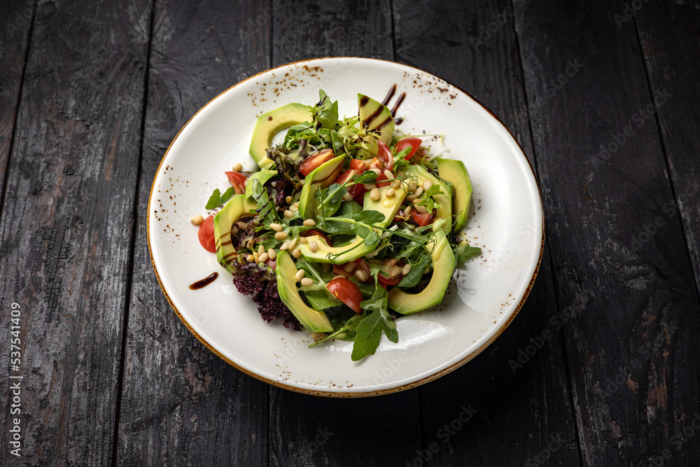 delicious salad in a plate on a dark table
delicious salad in a plate on a dark table