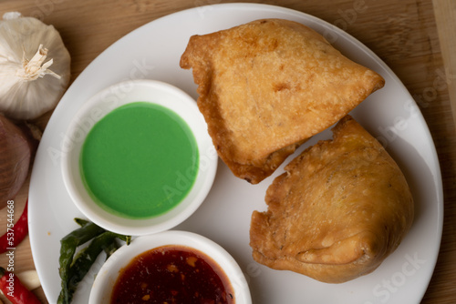 Veg Samosa - is a crispy and spicy Indian triangle shape snack which has crisp outer layer of maida filling of mashed potato, peas and spices