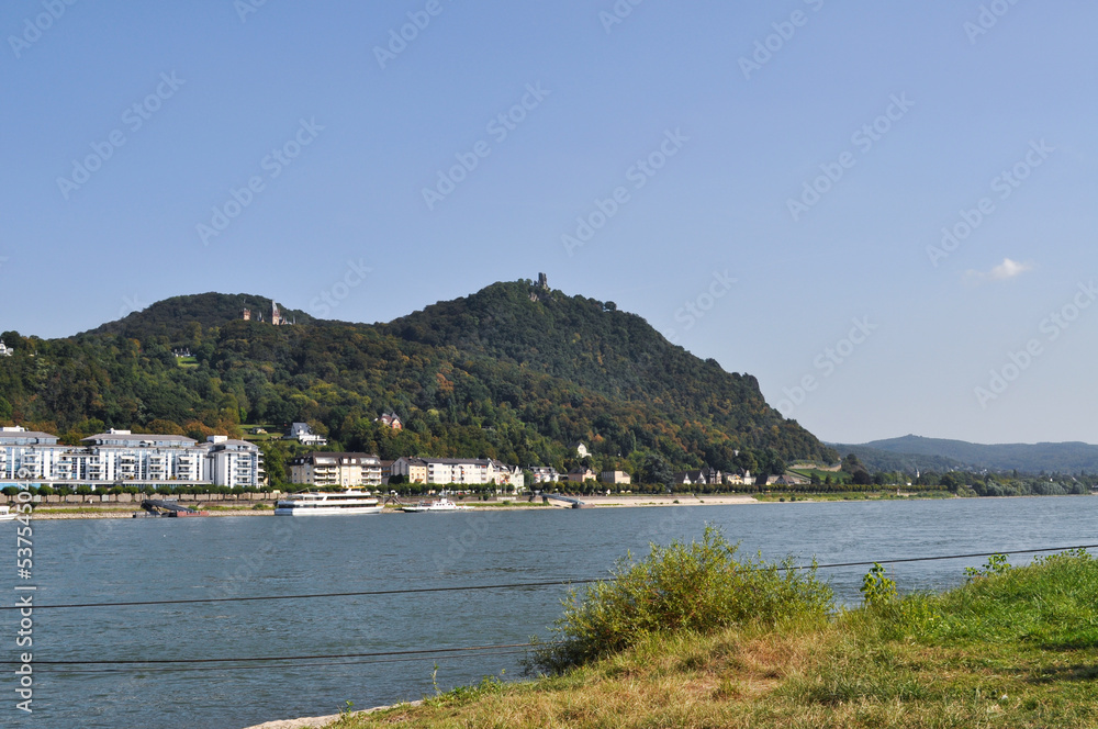 View of the Rhine River, the town of Königswinter on the opposite bank and Drachenfels Castle on the heights above. North Rhine-Westphalia, Germany.