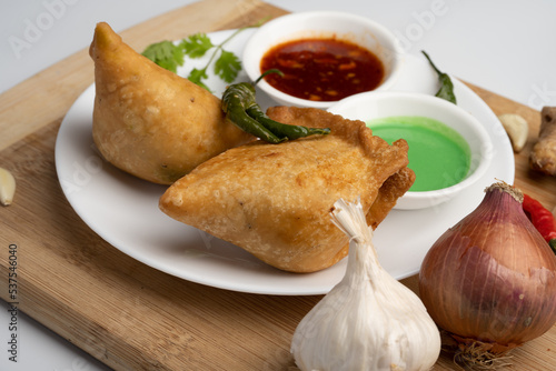 Veg Samosa - is a crispy and spicy Indian triangle shape snack which has crisp outer layer of maida filling of mashed potato, peas and spices