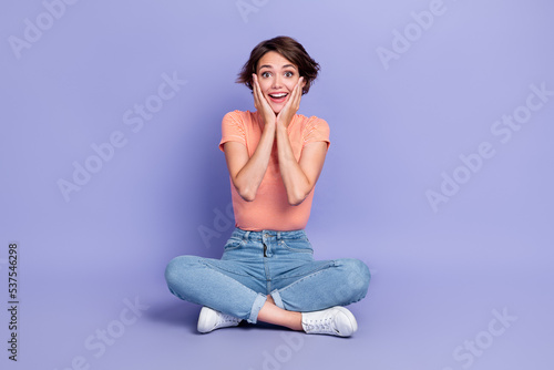 Full body photo of cute young lady palms touch cheeks impressed excited dressed stylish striped look isolated on purple color background