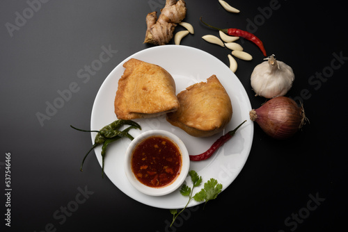 Veg Samosa - is a crispy and spicy Indian triangle shape snack which has crisp outer layer of maida filling of mashed potato, peas and spices