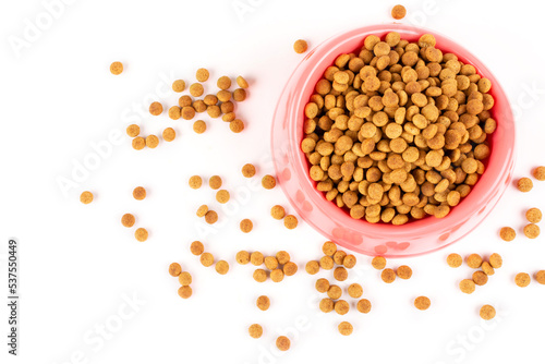 Pink bowl with dry food for a cat (dog) on a white isolated background. Template, design. Space for text. Balanced pet food.