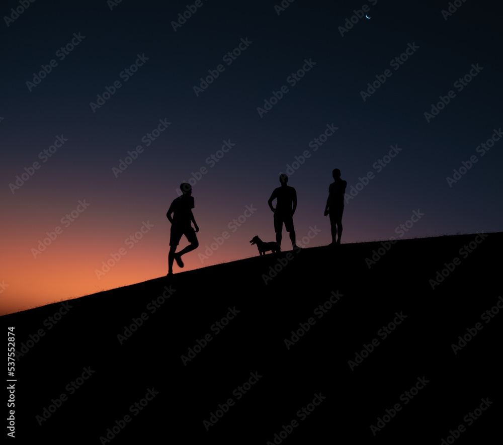 silhouettes on a hill