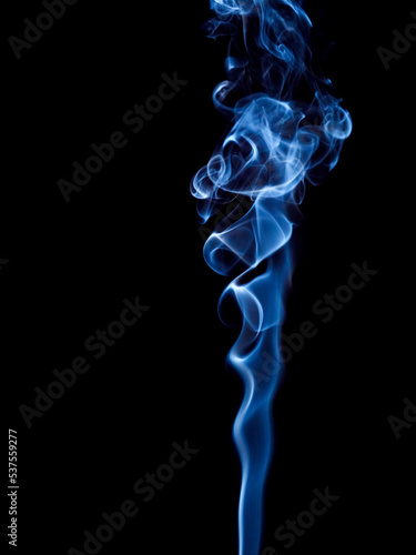 A stream of blue smoke twists into a spiral and rises up