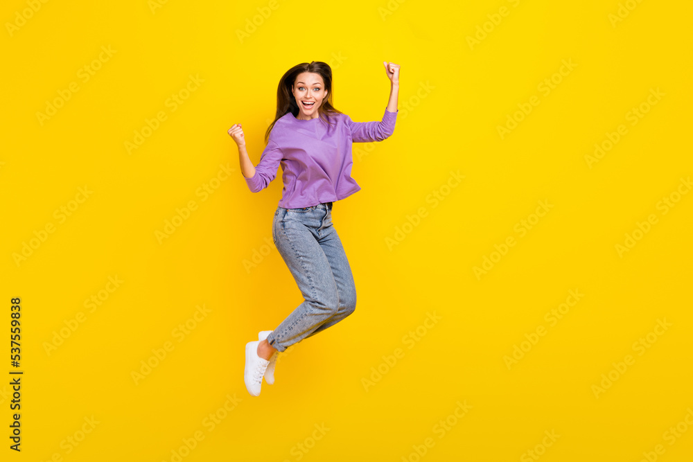Full length photo of overjoyed lady wear trendy clothes rejoice glad triumph hooray yes empty space isolated on yellow color background Full length photo of overjoyed lady wear trendy clothes rejoice glad triumph hooray yes empty space isolated on yellow color background