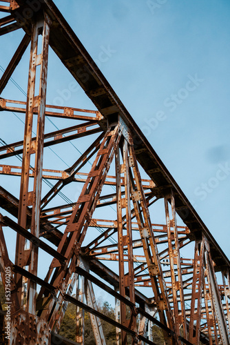 old metal bridge with blue sky in the background