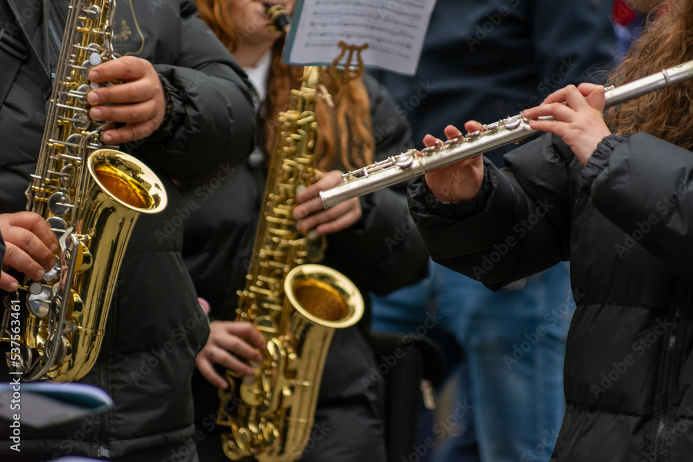 Fototapeta premium Musicians From A Popular Band Playing Traverse Flute and Saxophones During A Religious Procession
