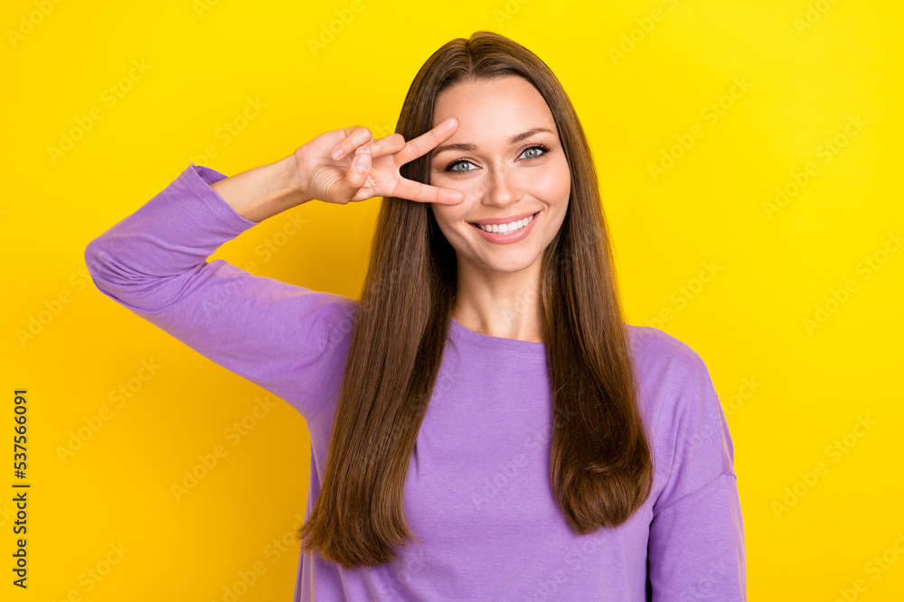 Closeup photo of cute charming good mood woman wear stylish purple pullover toothy smiling cover face v-sign carefree isolated on yellow color background Closeup photo of cute charming good mood woman wear stylish purple pullover toothy smiling cover face v-sign carefree isolated on yellow color background