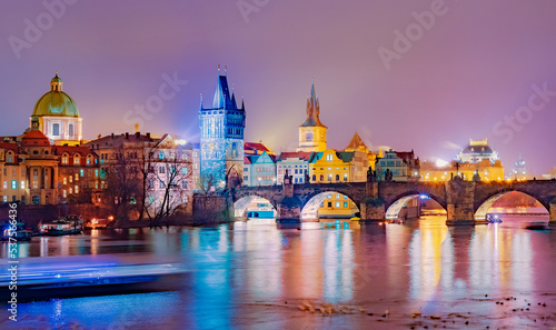 Cityscape view of Charles arch bridge architecture accros the river Vltava at night, in Prague