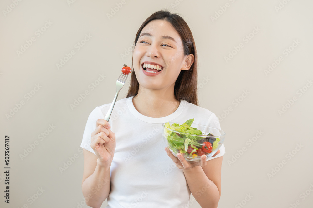 Diet, Dieting asian young woman or girl use fork at tomato on mix vegetables, green salad bowl, eat food is low fat good health. Nutritionist female, Weight loss for healthy person. Diet, Dieting asian young woman or girl use fork at tomato on mix vegetables, green salad bowl, eat food is low fat good health. Nutritionist female, Weight loss for healthy person.