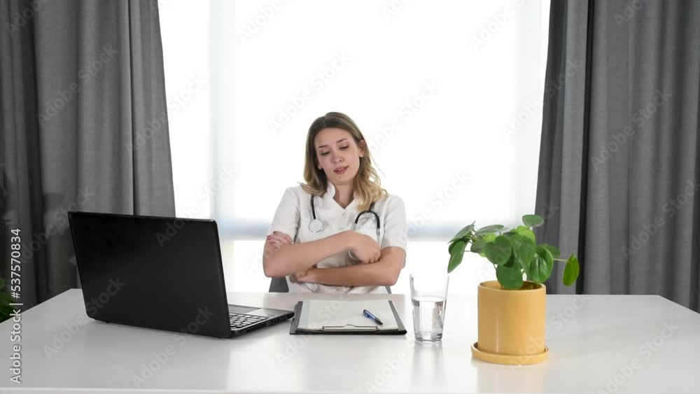 Young depressed woman doctor sitting in office room at the hospital taking a break from stressed work. Female medical worker under the psychical pressure resting alone from hard work at the clinic. Young depressed woman doctor sitting in office room at the hospital taking a break from stressed work. Female medical worker under the psychical pressure resting alone from hard work at the clinic.