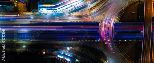 Fototapeta Naklejka Na Ścianę i Meble -  Expressway top view, Road traffic an important infrastructure, car traffic transportation above intersection road in city night, aerial view cityscape of advanced innovation, financial technology	